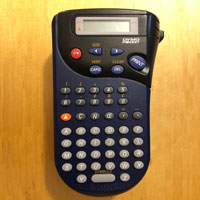 A portable label maker - hand-held with a Qwerty keyboard and some other buttons for adjusting the print